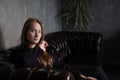 portrait of beautiful confident brunette woman in black in grey dark room. business woman. feminine. millennial people