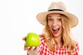 Portrait of beautiful country girl with apple over white background. Royalty Free Stock Photo