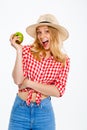 Portrait of beautiful country girl with apple over white background. Royalty Free Stock Photo