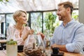 Portrait of beautiful couple in a restaurant, on romantic date. Husband and wife clinking champagne glasses, making a Royalty Free Stock Photo