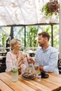 Portrait of beautiful couple in a restaurant, on romantic date. Husband and wife are clinking champagne glasses, making Royalty Free Stock Photo