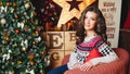 Portrait of beautiful curly women near christmas tree. Celebration Royalty Free Stock Photo