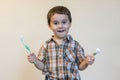 portrait of a beautiful cute caucasian blond boy with a toothbrush. Little boy brushing teeth and smiling while taking care of