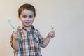 portrait of a beautiful cute caucasian blond boy with a toothbrush. Little boy brushing teeth and smiling while taking care of