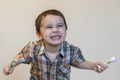 Portrait of a beautiful cute caucasian blond boy with a toothbrush. Little boy brushing teeth and smiling while taking care of