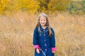 portrait of beautiful cute girl in clothes on background of autumn nature Royalty Free Stock Photo