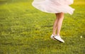 Portrait of a beautiful cute girl in a romantic brunette skirt with in a green garden posing and smiling