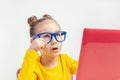 Portrait of beautiful cute little girl with glasses using laptop computer Royalty Free Stock Photo