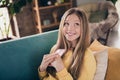 Portrait of beautiful cute lovely schoolgirl teenager dreaming holding new apple iphone 15 surprise from parents sitting