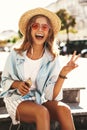 Beautiful cute smiling blond teenager model in summer hipster clothes Royalty Free Stock Photo