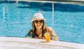 Portrait of beautiful cute smiling young woman lady girl in a bikini, hat, and sunglasses holding tropical lemonade Royalty Free Stock Photo