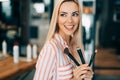 Portrait of the beautiful woman with make-up brushes Royalty Free Stock Photo