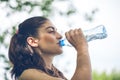 Portrait of beautiful dark-haired girl drinking water at summer Royalty Free Stock Photo