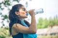 Portrait of beautiful dark-haired girl drinking water at summer Royalty Free Stock Photo