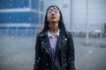 Portrait of a beautiful dark-haired girl in the rain.