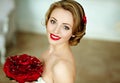 Portrait of beautiful delicate sensual brown-haired girl in a white dress with an unusual bouquet of red rose petals, smiling hap Royalty Free Stock Photo