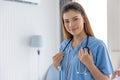 Portrait beautiful doctor or nurse woman model standing happy smiling indoor Royalty Free Stock Photo