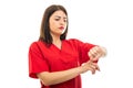 Portrait of beautiful doctor wearing scrubs making late gesture