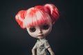 Close up portrait of beautiful doll, pink hairstyle, gray t-shirt. Black background.