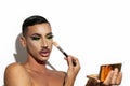 Beautiful drag queen applying makeup with white background Royalty Free Stock Photo
