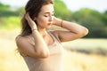 Portrait of beautiful girl in summer field in a dress , a young woman enjoying nature Royalty Free Stock Photo