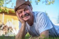 Portrait of beautiful elderly man Lies on the grass smiling and looking at the camera.