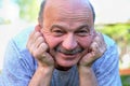 Portrait of beautiful elderly man Lies on the grass smiling and looking at the camera. Royalty Free Stock Photo