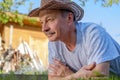 Portrait of beautiful elderly man Lies on the grass smiling and looking at the camera. Royalty Free Stock Photo