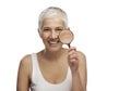 Portrait of a beautiful elderly woman holding a magnifying glass, isolated Royalty Free Stock Photo