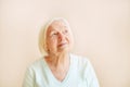 Portrait of beautiful elderly woman looking up, space text