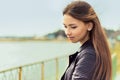 Portrait of a beautiful elegant gentle graceful girl with dark hair standing by the lake