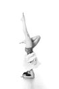 Portrait of beautiful elegant slim active sporty young woman practicing standing on head yoga pose in yoga studio