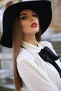 Portrait of beautiful elegant woman with dark hair in black hat Royalty Free Stock Photo