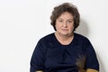 Portrait of beautiful elegant woman in a well-kept older srudii on a white background with makeup and without makeup