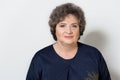 Portrait of beautiful elegant woman in a well-kept older srudii on a white background with makeup and without makeup