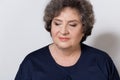 Portrait of beautiful elegant woman in a well-kept older srudii on a white background with makeup and without makeup