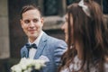 Portrait of beautiful emotional wedding couple smiling and walking in european city. Provence wedding. Stylish happy bride and Royalty Free Stock Photo