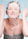 Portrait of beautiful emotional woman washing face