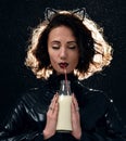 Portrait of beautiful fashion woman drinking milk from the bottle with straw Royalty Free Stock Photo