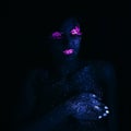 Portrait of Beautiful Fashion Woman in Neon UF Light. Model Girl with Fluorescent Creative Psychedelic MakeUp, Art Design of Royalty Free Stock Photo