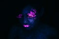 Portrait of Beautiful Fashion Woman in Neon UF Light. Model Girl with Fluorescent Creative Psychedelic MakeUp, Art Design of Royalty Free Stock Photo