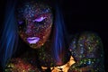 Portrait of Beautiful Fashion Woman in Neon UF Light. Model Girl with Fluorescent Creative Psychedelic MakeUp, Art Royalty Free Stock Photo