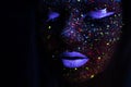 Portrait of Beautiful Fashion Woman in Neon UF Light. Model Girl with Fluorescent Creative Psychedelic MakeUp, Art