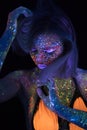Portrait of Beautiful Fashion Woman in Neon UF Light. Model Girl with Fluorescent Creative Psychedelic MakeUp, Art Royalty Free Stock Photo