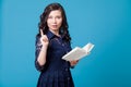 Portrait of a beautiful fashionable Asian woman with a teaching book Royalty Free Stock Photo