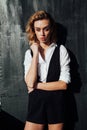 Portrait of a beautiful fashionable blonde woman in black shorts white blouse Royalty Free Stock Photo