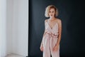 Portrait of a beautiful fashionable blonde woman in a pink jumpsuit on a black white background Royalty Free Stock Photo