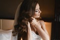 Portrait of beautiful and fashionable brunette model girl with professional bright makeup and hairstyle, young bride in lace dress Royalty Free Stock Photo