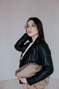 Portrait of a beautiful oriental fashionable brunette woman in a black leather jacket Royalty Free Stock Photo
