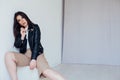 Portrait of a beautiful oriental fashionable brunette woman in a black leather jacket Royalty Free Stock Photo